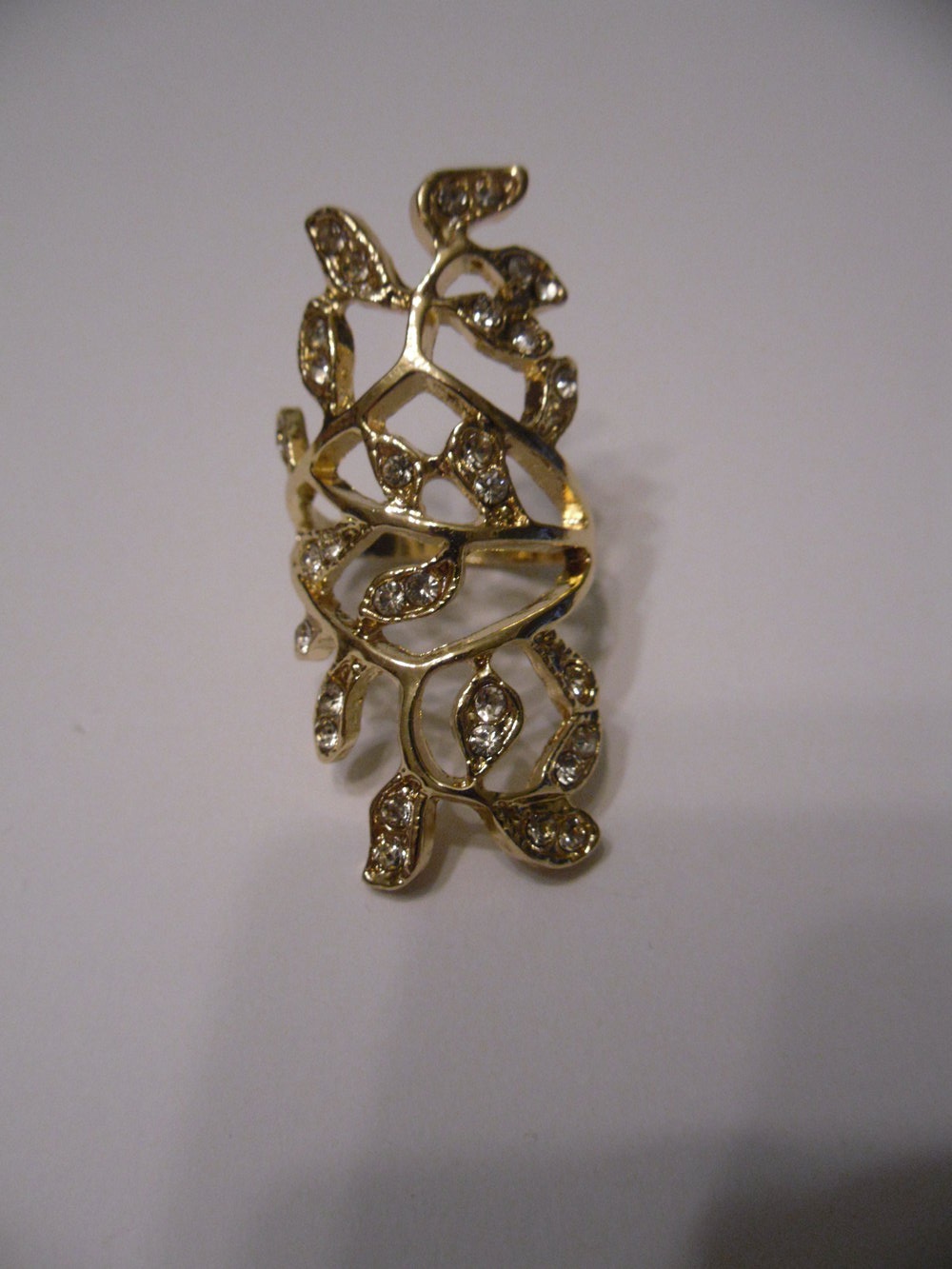 Goldener Ring in filigraner Blätteroptik mit weißen Strasssteinen