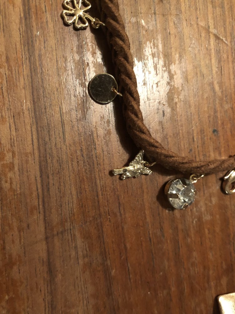 Braunes Armbändchen mit goldenen Anhängern 