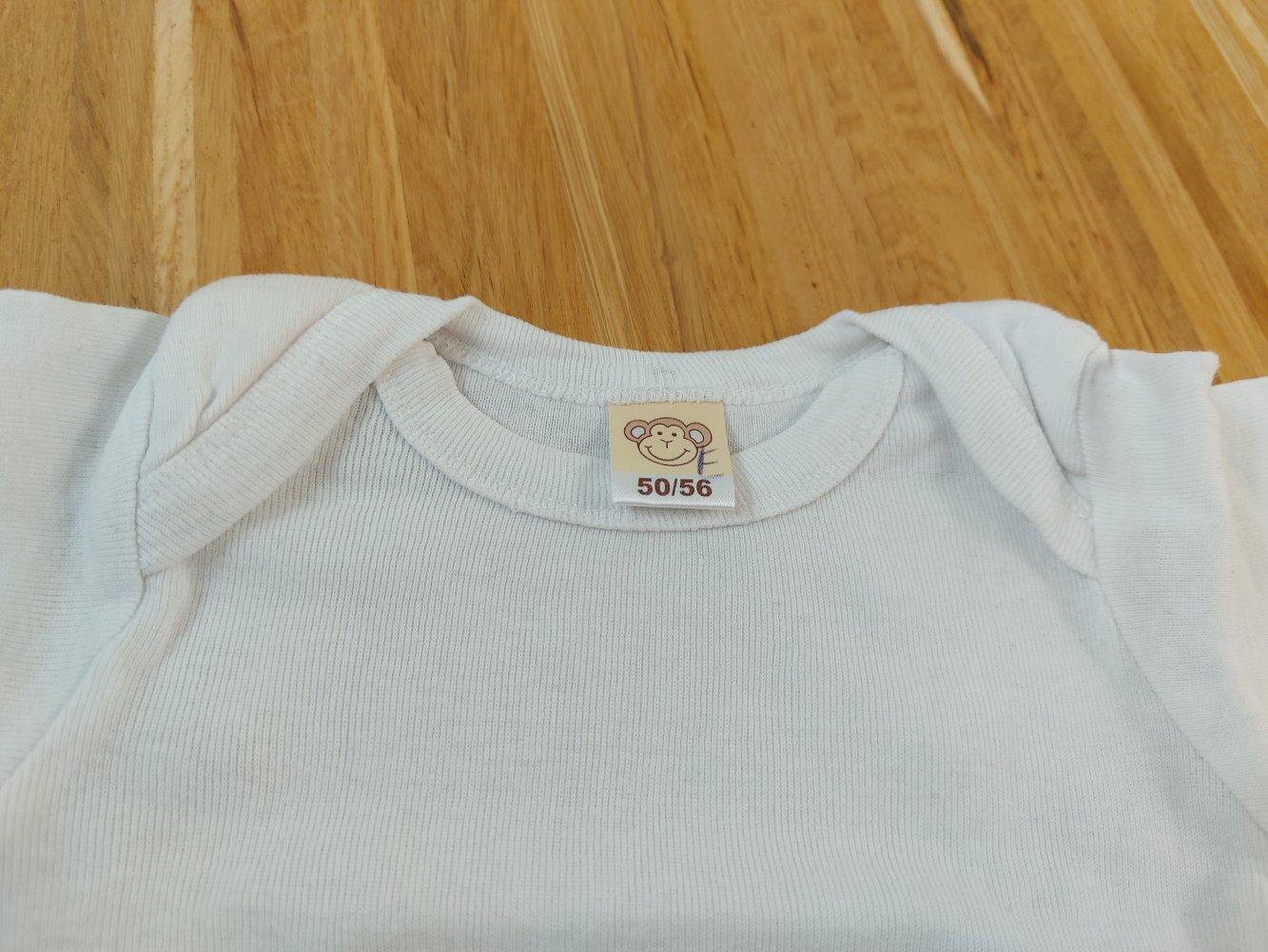 weißer Langarmbody Gr. 50/56